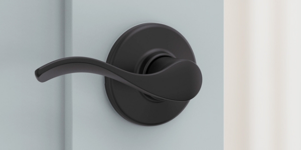 Kwikset Lever in matte black installed in ocean blue door